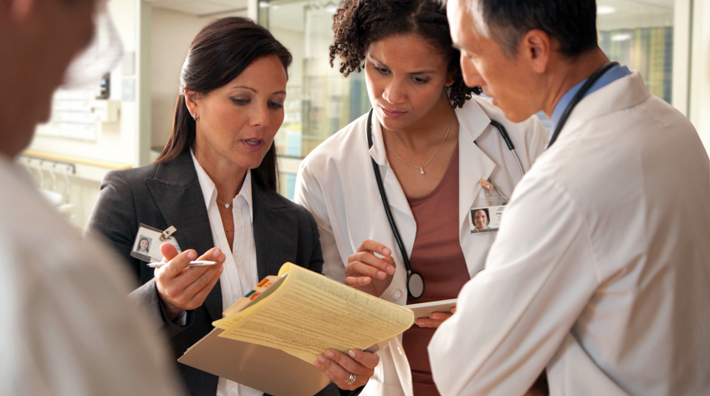 Hospital staff discussing patient charts